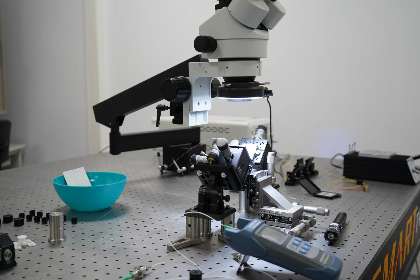 Microscope above fibre alignment stages on an optical laboratory bench