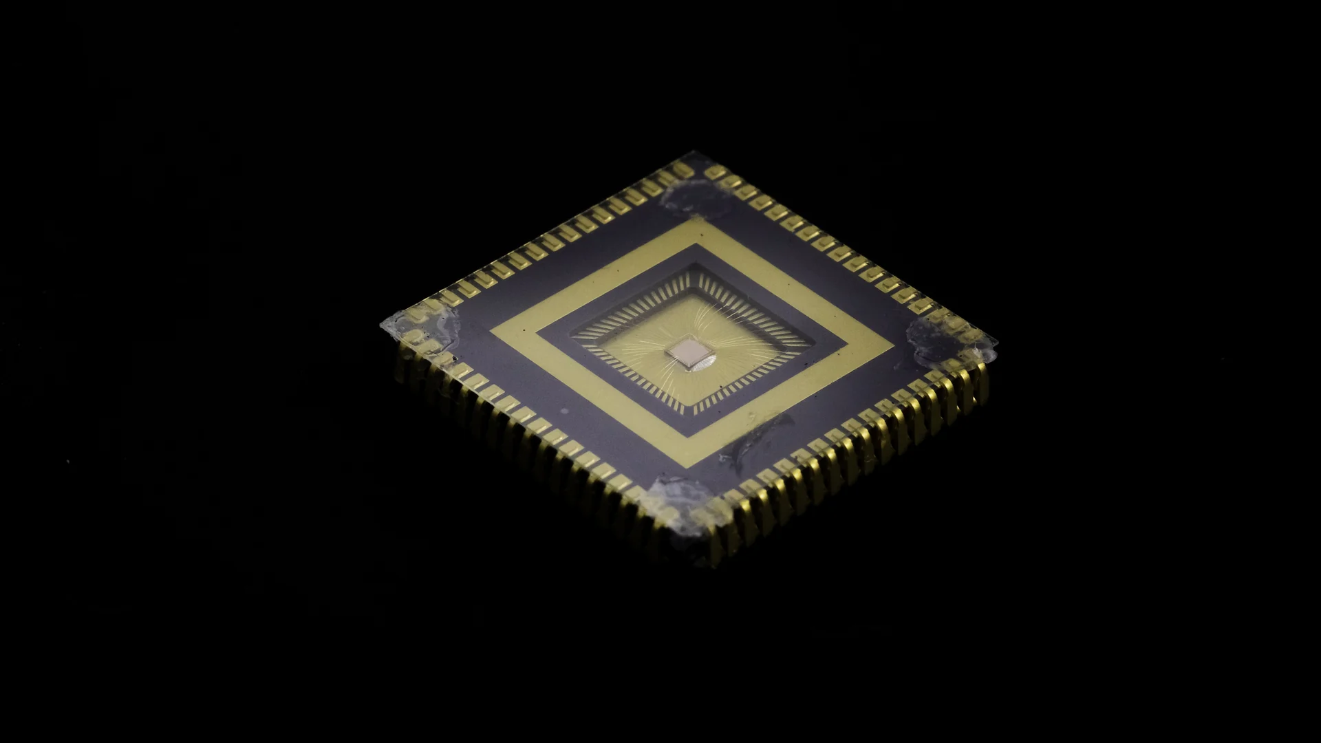 Exposed wire-bonded chip package with gold contacts, photographed in our laboratory