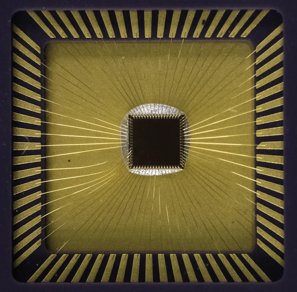 Close-up of an exposed die and bond wires inside a chip package